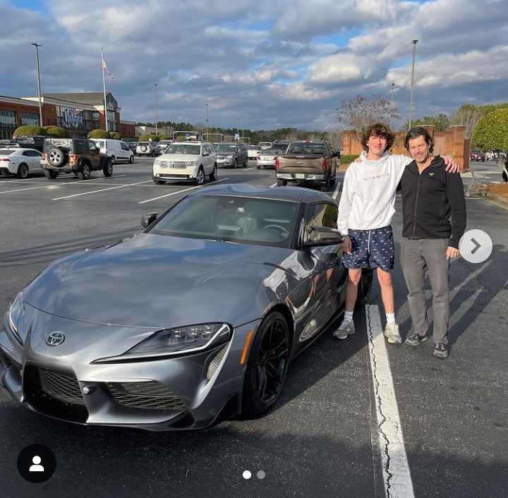 Image - Baylen Levine with his dad, Adam Levine, in a picture with the new car he bought his dad. (Source: @baylenlevine / Instagram). 