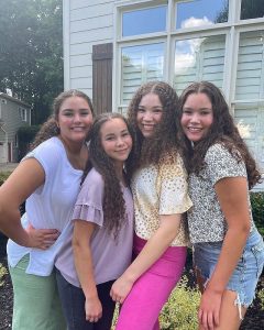 Image - Olivia Haschak in a family photo with her older sisters, Madison, Gracie, and Sierra. 