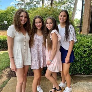 Image - Olivia Haschak in a family photo with her older sisters, Madison, Gracie, and Sierra. 