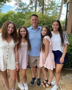 Image - Olivia Haschak in a family photo with her dad, John, and older sisters, Madison, Gracie, and Sierra. 