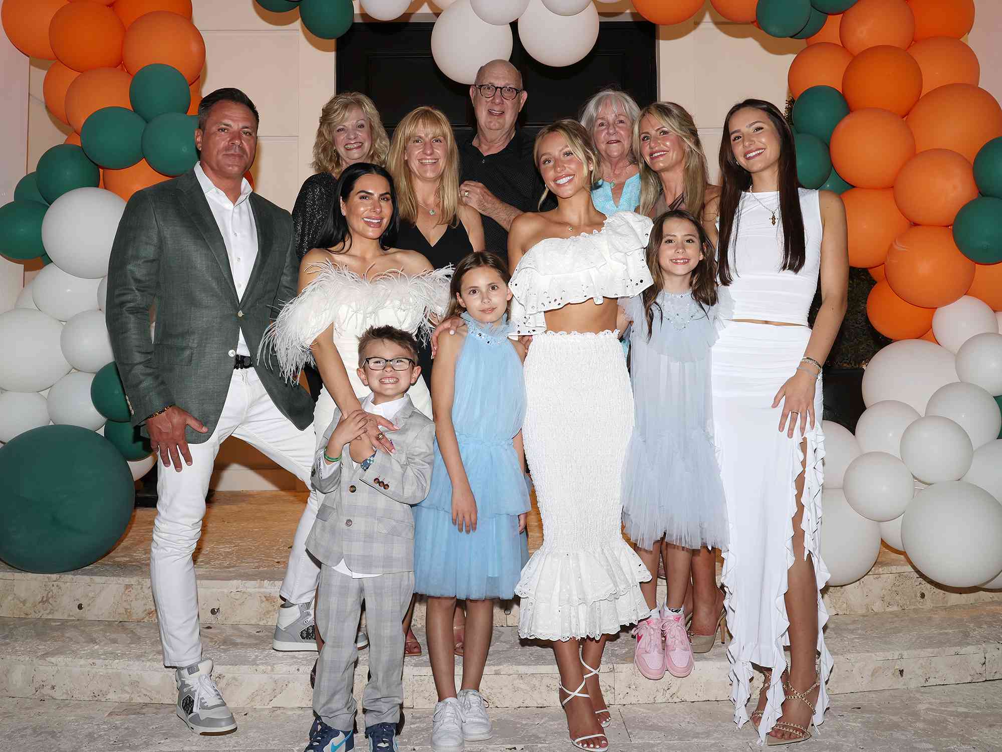 Image — Alix Earle in a family photo with her parents, step-mom, sister, half-siblings, and grandparents.