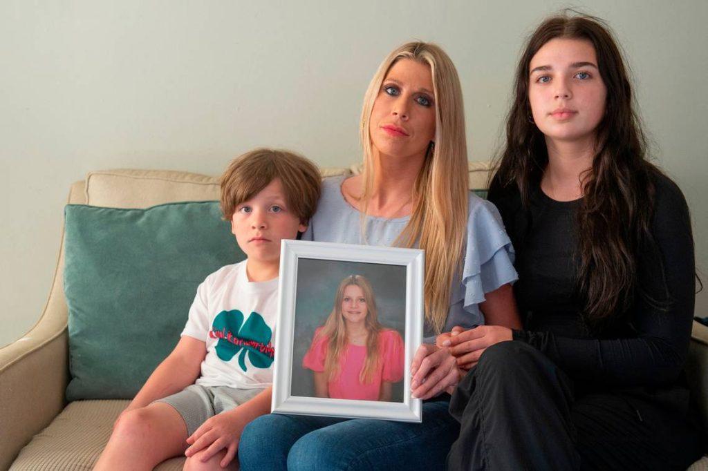 Image - Taylor Wyatt in a family photo with her mom, Heather Wyatt, and younger brother, Ryker Wyatt, as they raised awareness for mental health following her sister's death. 